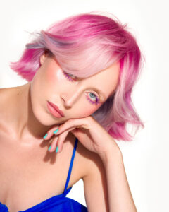 Well model posing with pink coloured hair