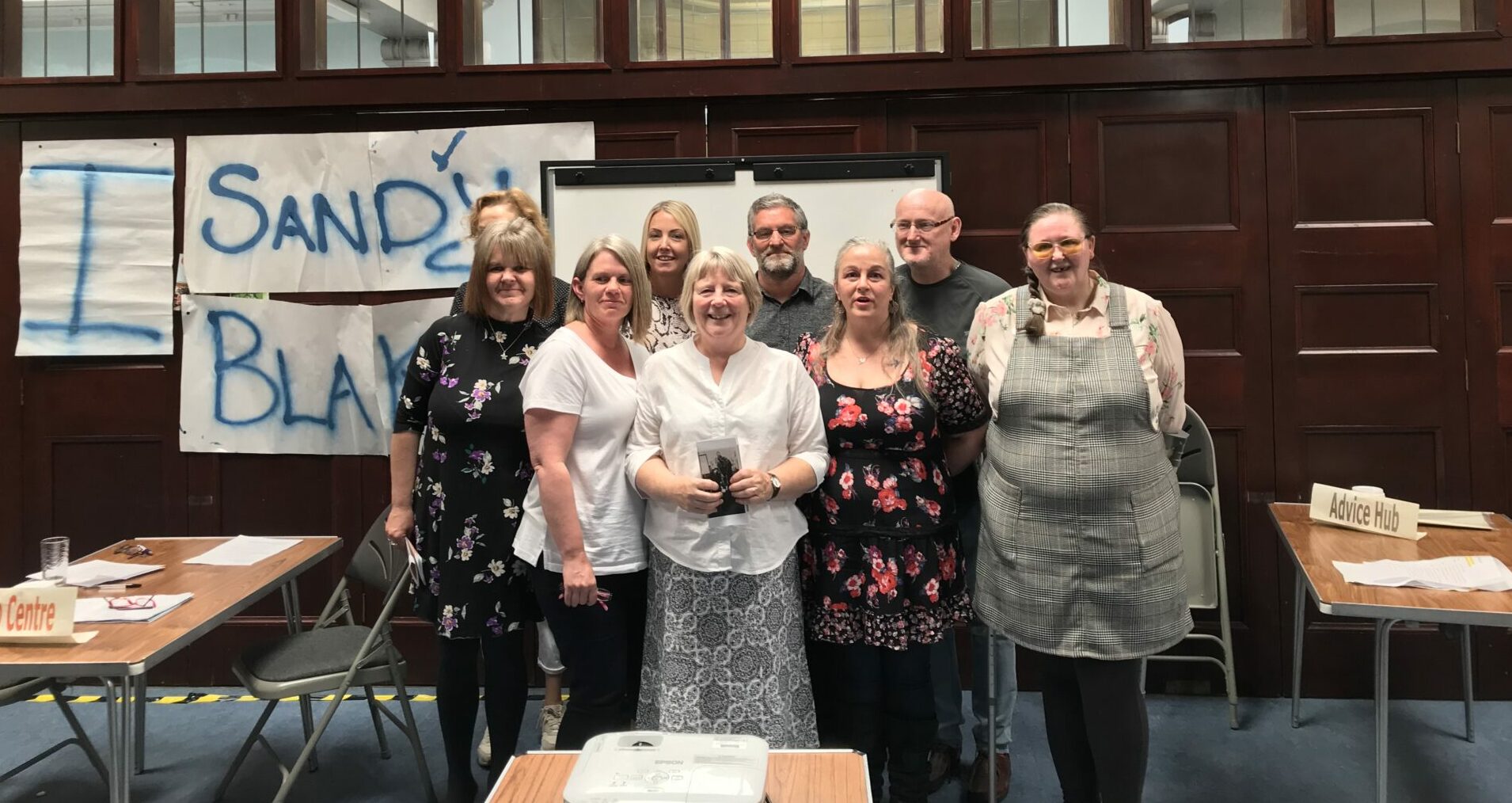 Participants from the Health Issues in the Community course, which is on the SCQF, stand together in a group, smiling at the camera.