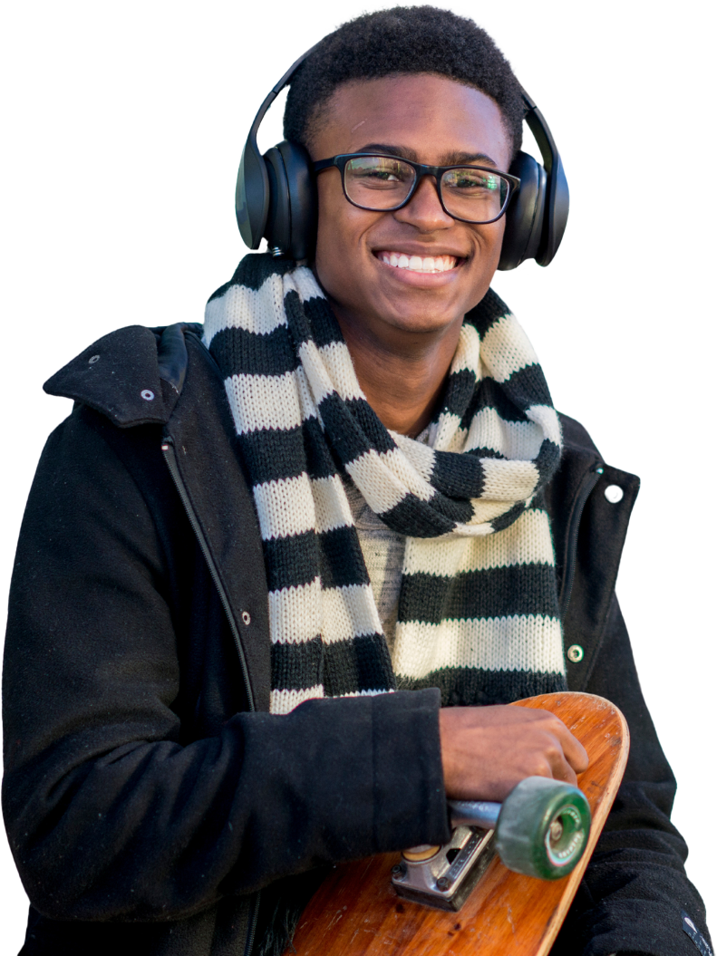 A young boy with headphones on his head and a scarf around his neck. He's holding a skateboard and smiling. He represents the learners that the SCQF supports