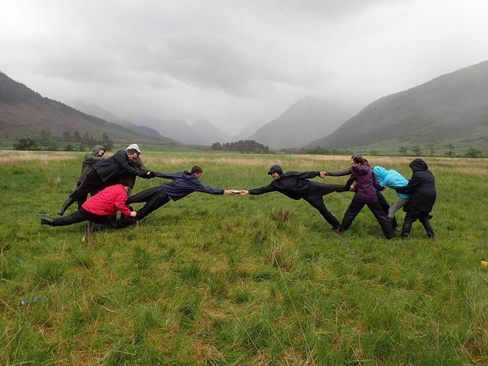 Group of Venture Scotland students doing team building exercise outdoors at Glen Etive