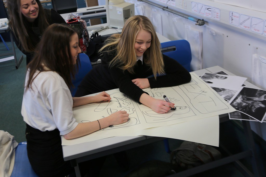 Female pupils at Currie Community High School working together on a project
