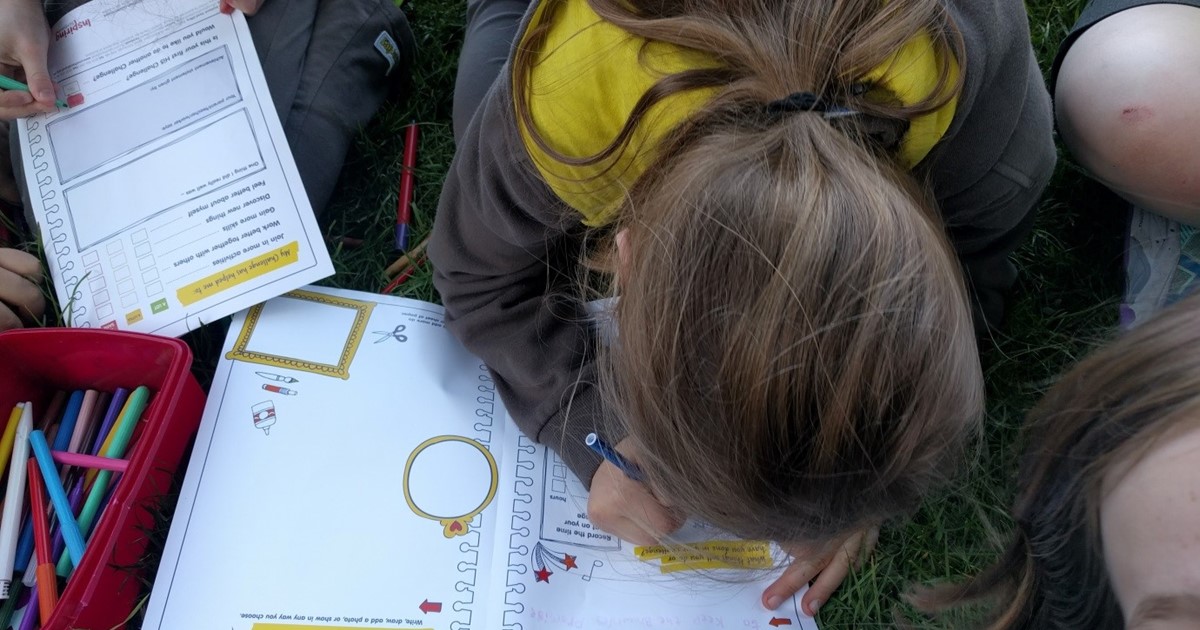 Group of Hi-5 students writing in their workbooks
