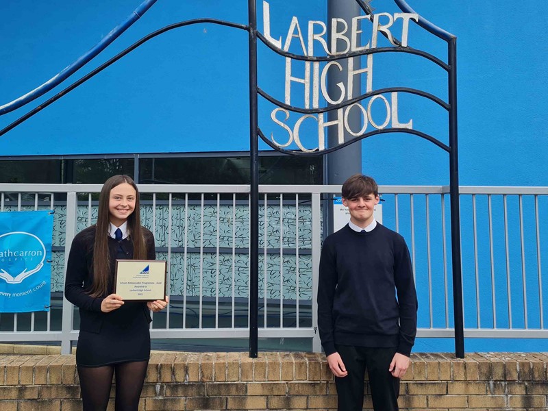 2 pupils from Larbert High School holding gold plaque 