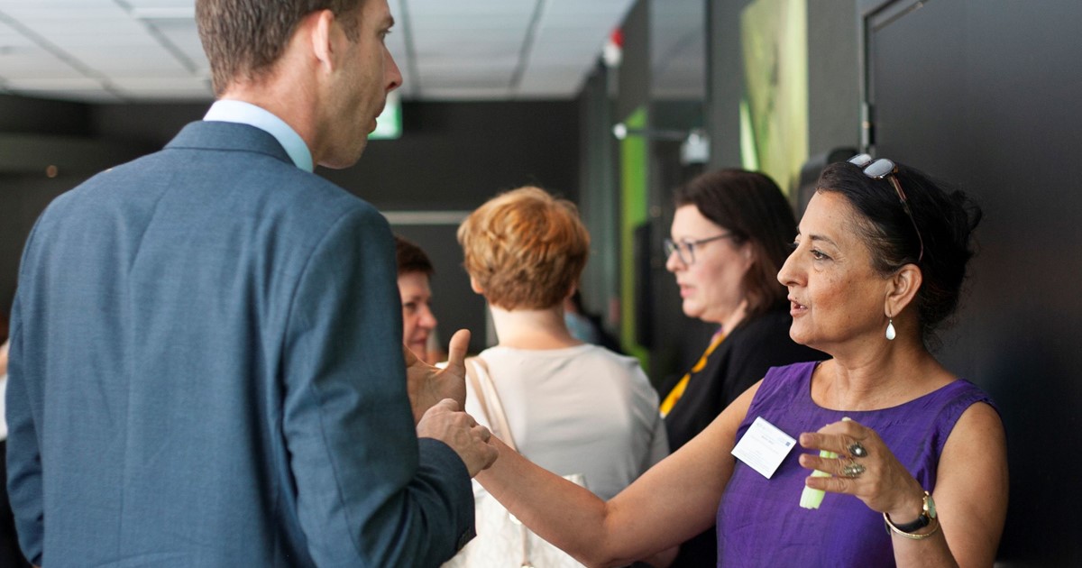 Delegates at the NQF-in meeting networking during a break