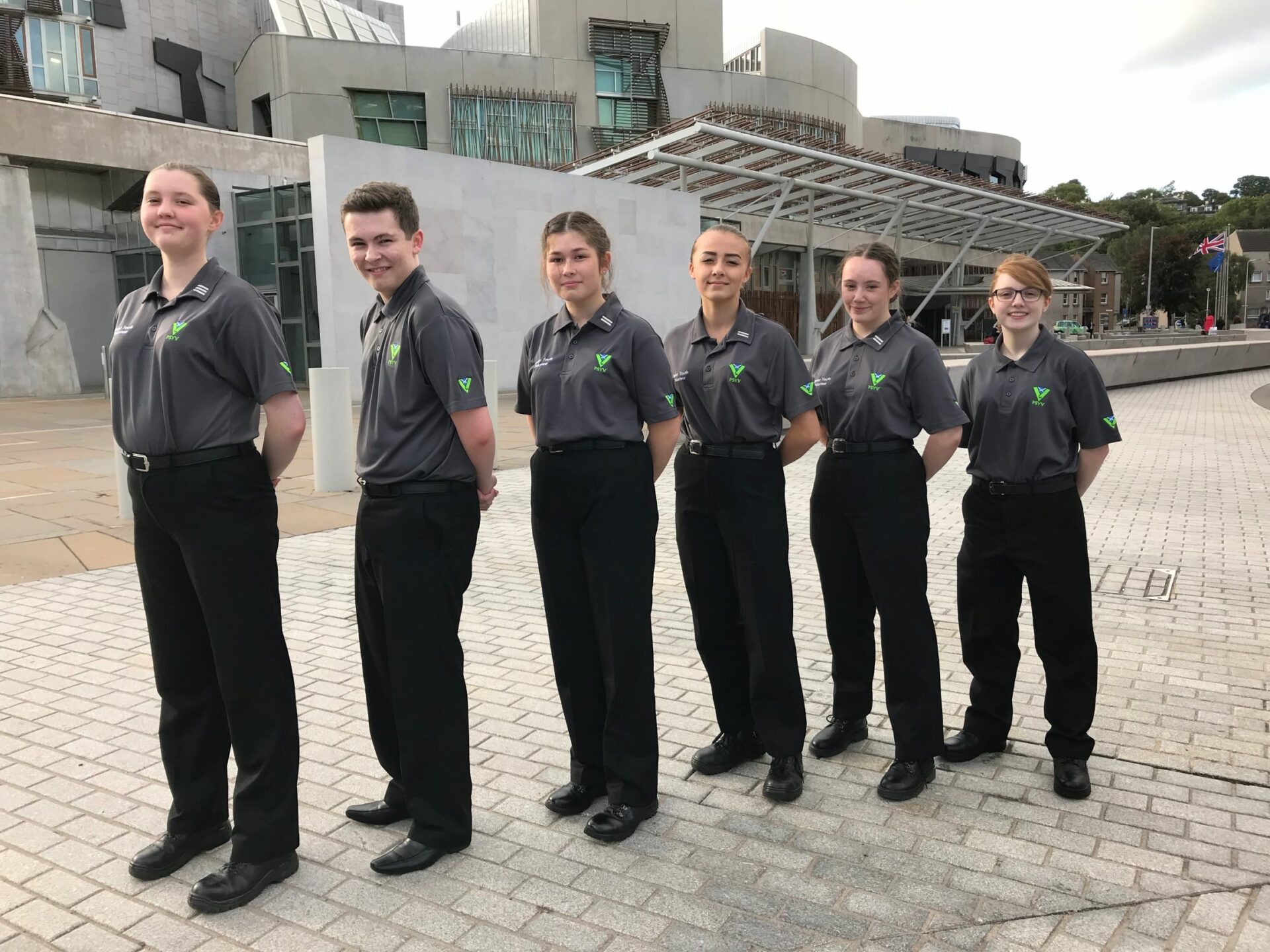 Group shot of PSYV students in uniform outside the Scottish Parliament building in Edinburgh