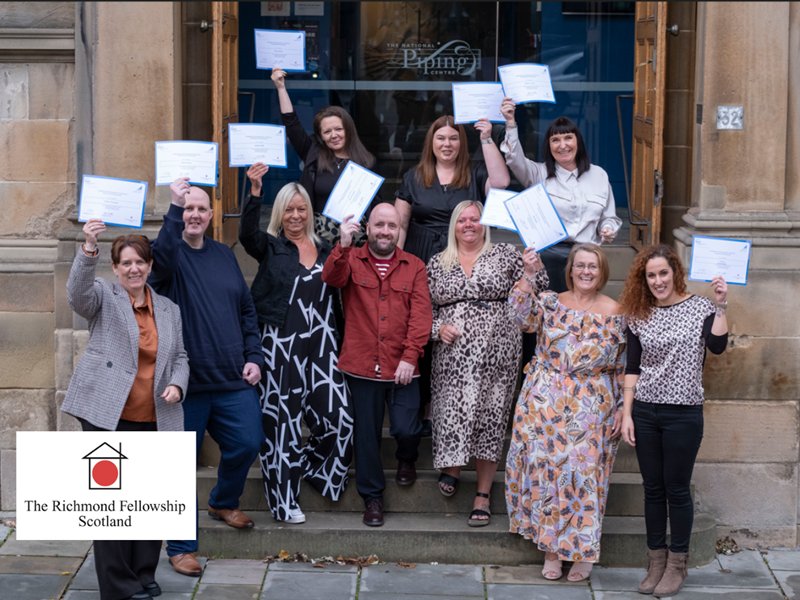 Staff from the Richmond Fellowship Scotland holding up their award certificates