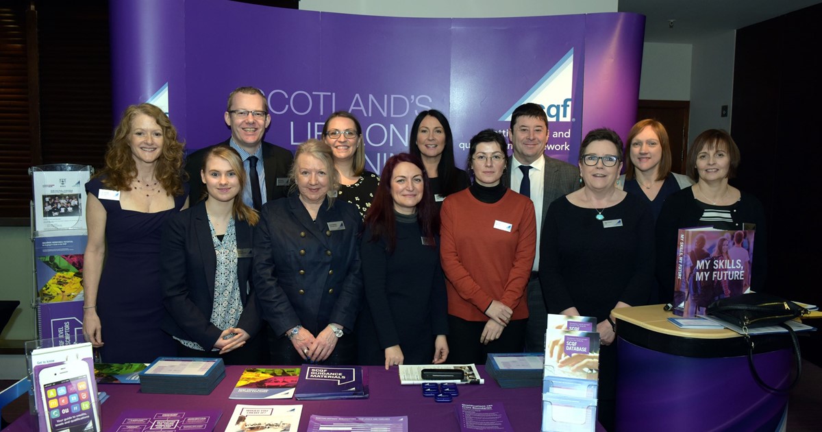 Group shot of the SCQF Partnership Executive Team in front of the SCQF stand at the SCQF Conference 2018