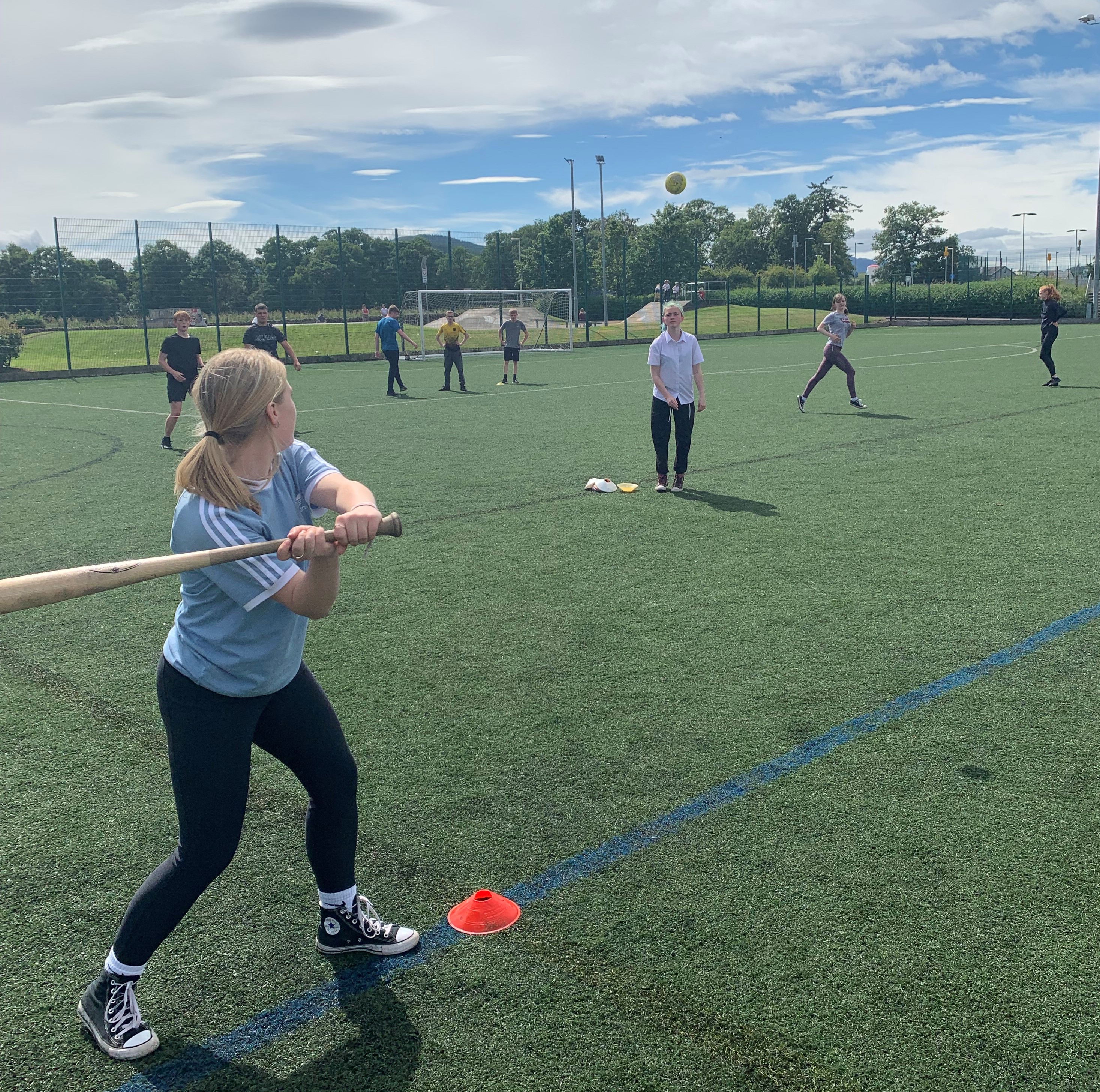 young people playing sport in a field