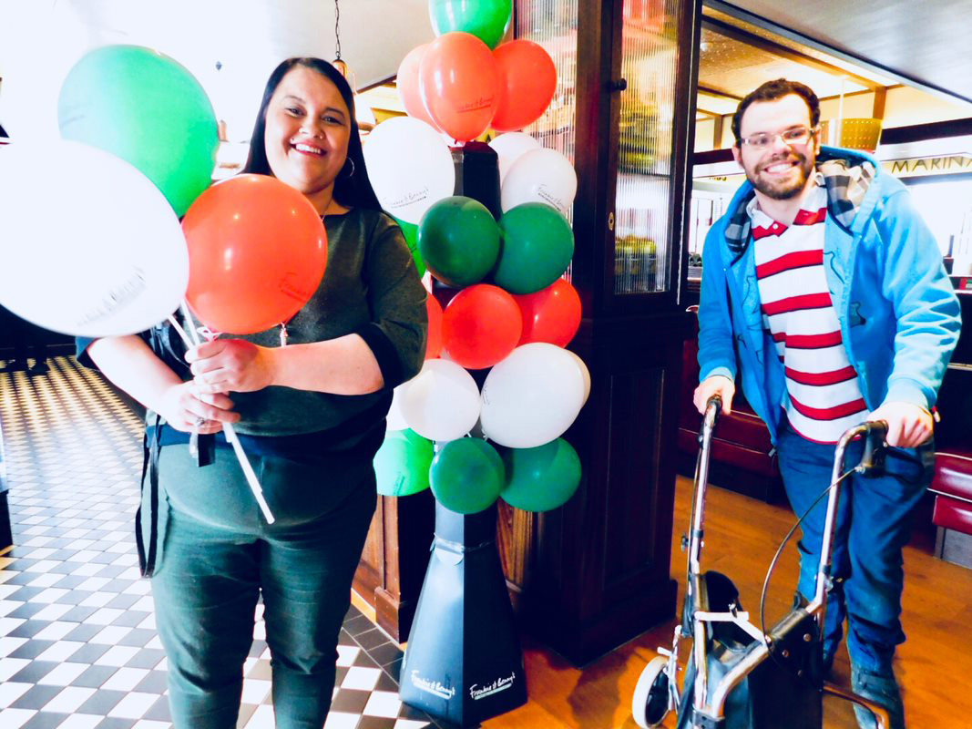 LEAD Scotland service users holding balloons and smiling at the camera