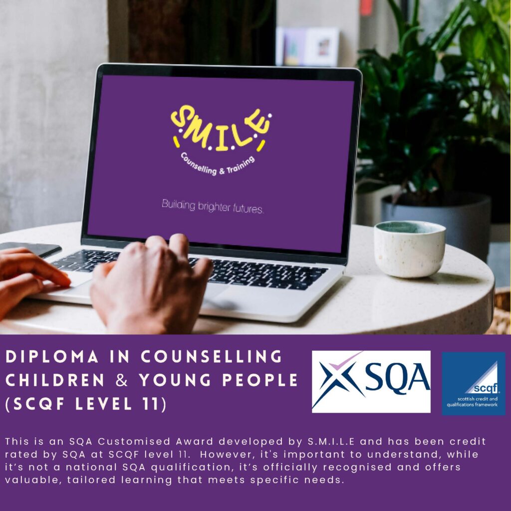 Laptop on table, open at SMILE Counselling and Training website homepage