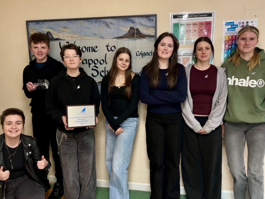 7 Ullapool High school pupils, with one pupil holding up a silver SCQF Ambassador plaque